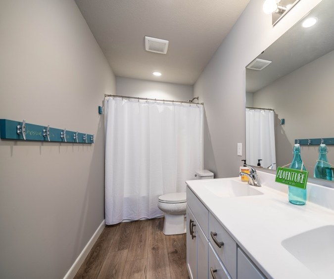 Bathroom with a double vanity, toilet and shower