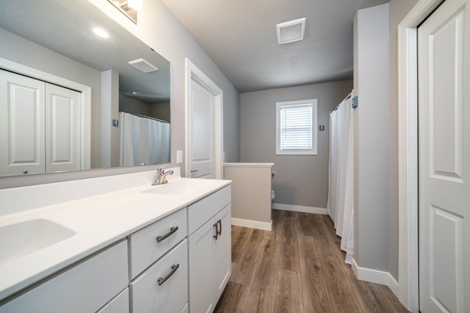 En suite bathroom with a vanity and shower