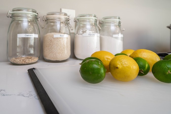 Lemons, limes and glass canisters on the counter