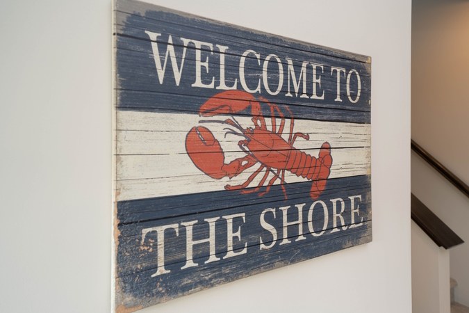 Welcome to the Shore sign with a red lobster