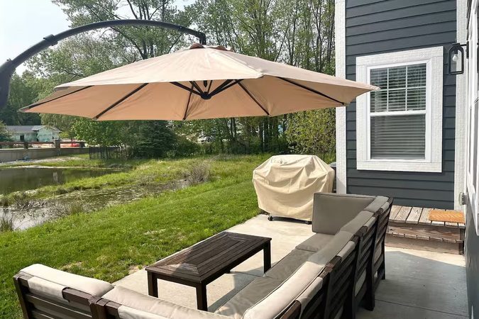 Back patio with outdoor seating overlooking the pond